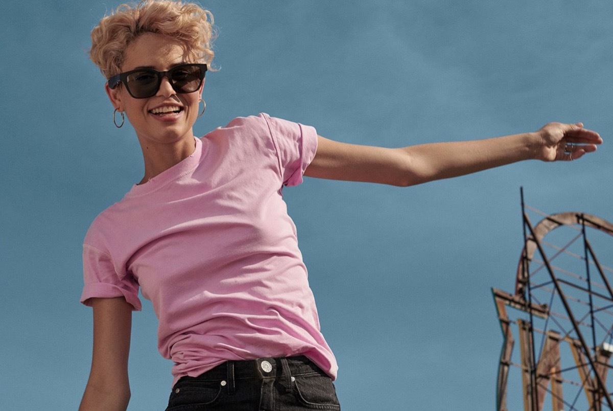 woman in pink shirt wearing black sunglasses