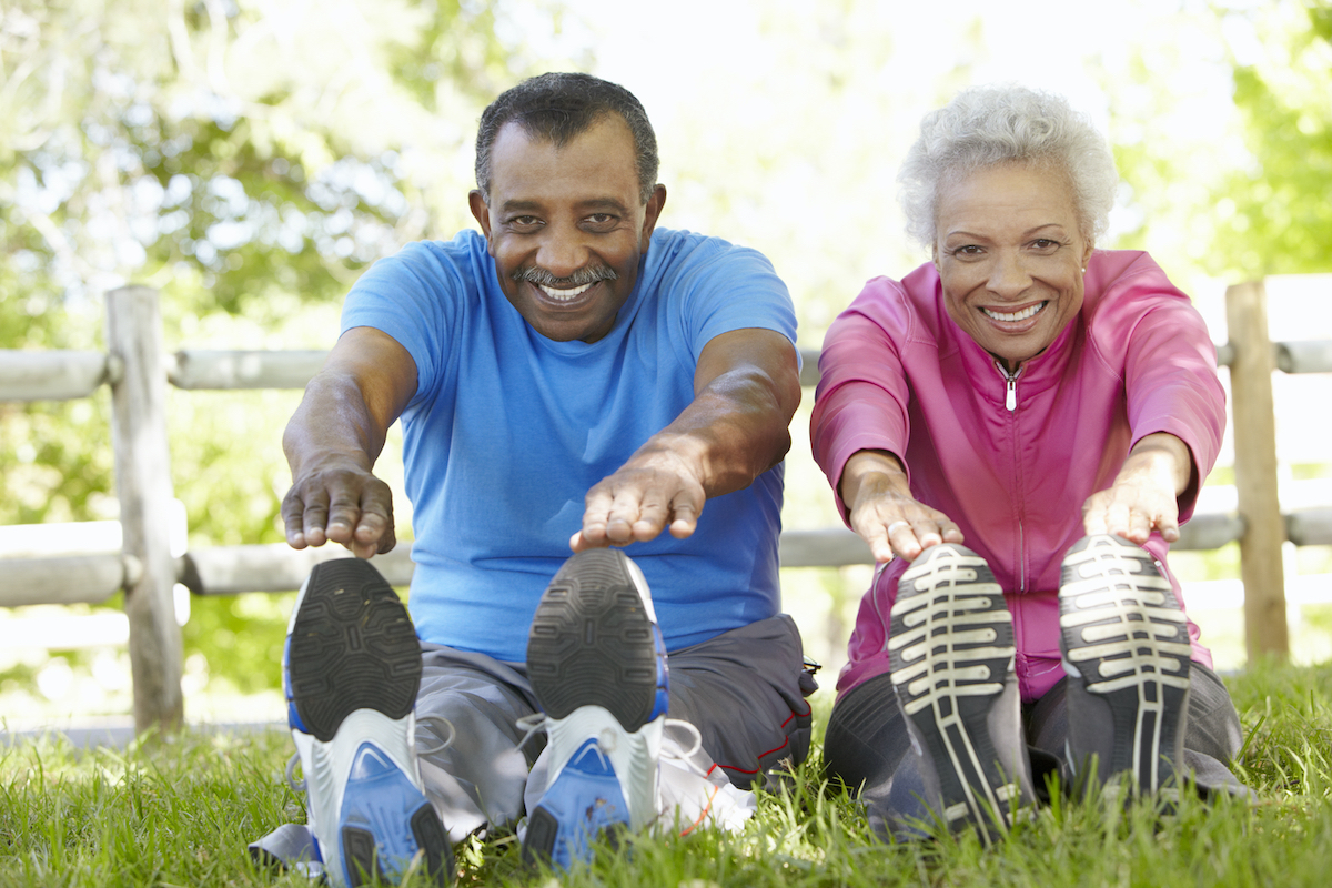 Senior African American Couple Exercising In Park