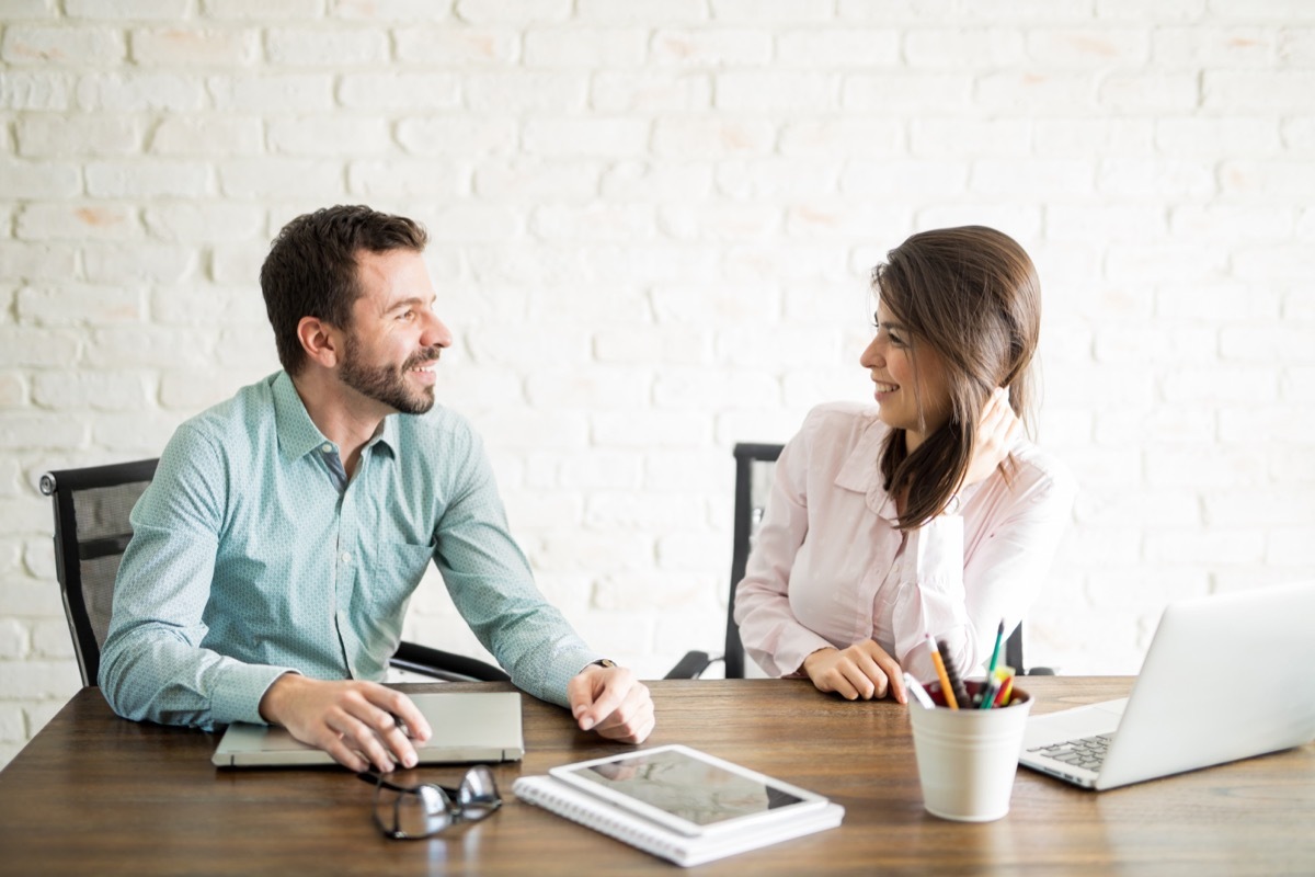 man and woman flirting in an office