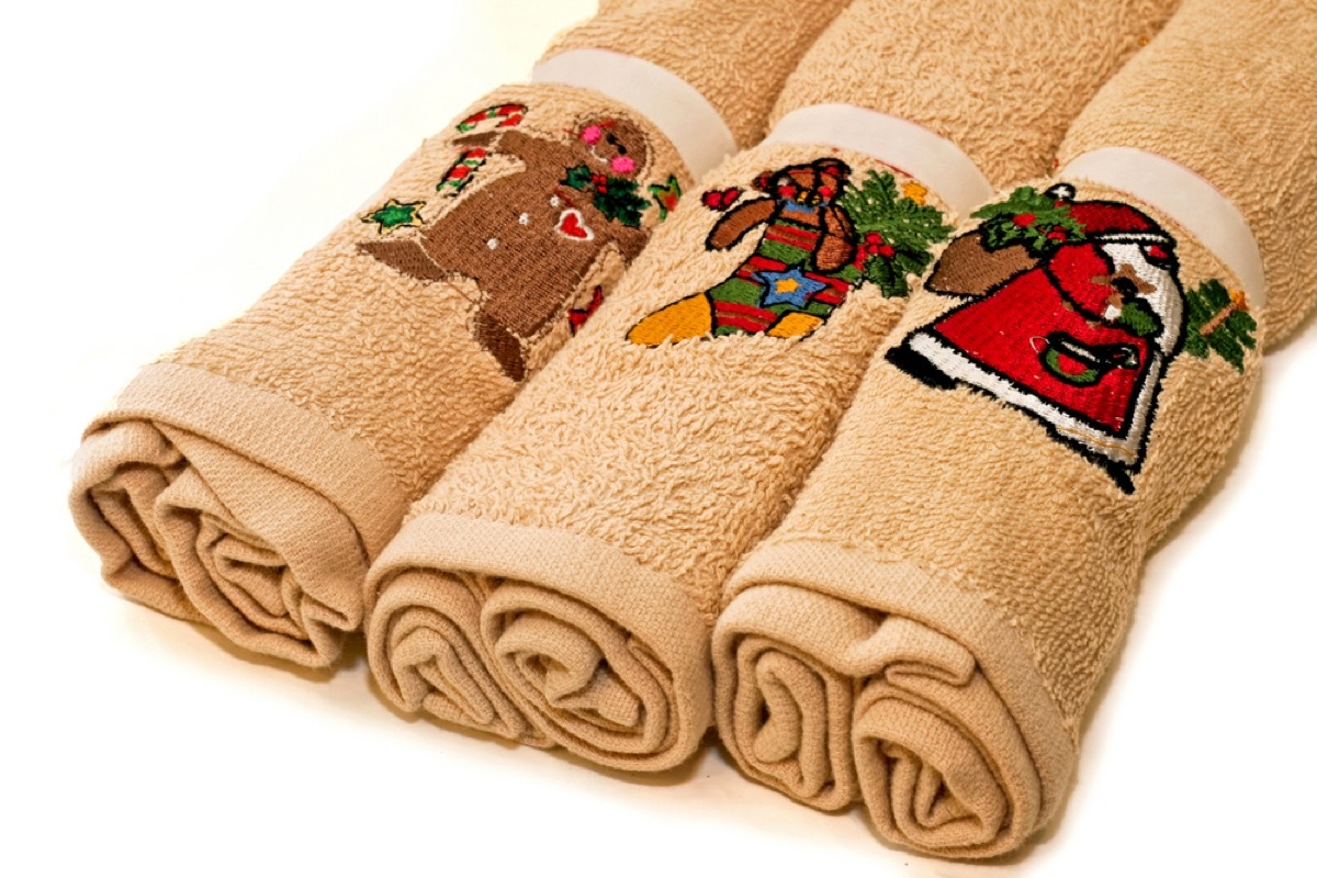 three rolled up holiday kitchen towels