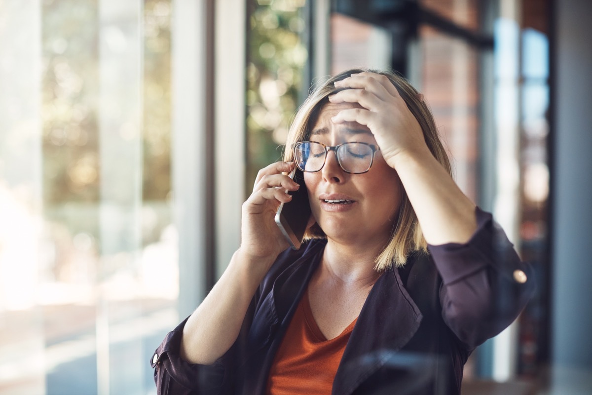 young woman distraught calling someone on the phone