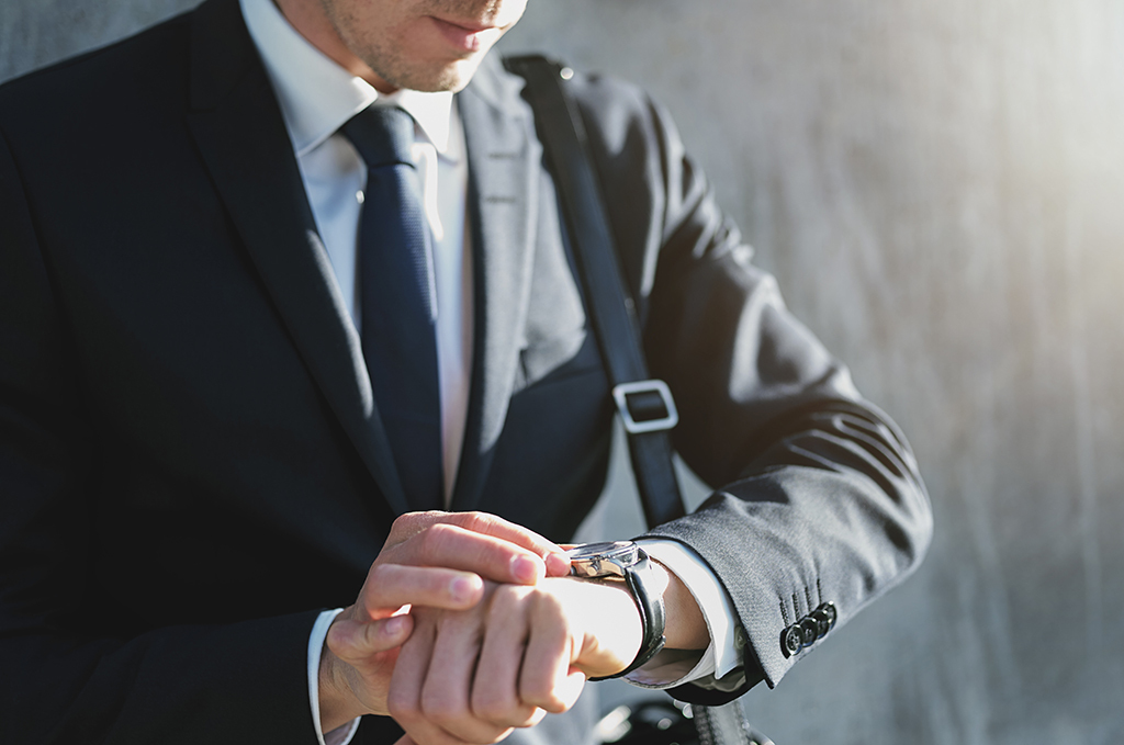 man running late checking watch