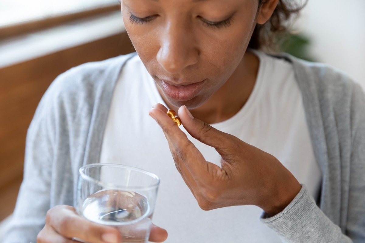 Woman Swallowing A Pill