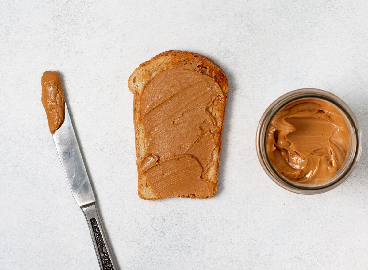 homemade butter in a jar spread on toast