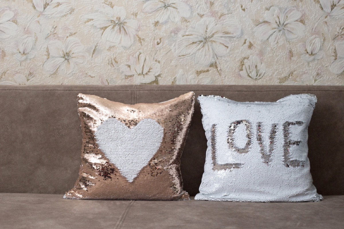 sequin pillows on couch, interior design mistakes