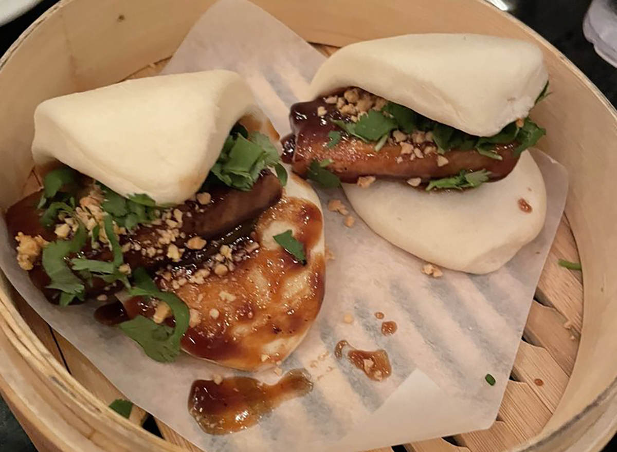 two pork belly bao in steamer basket