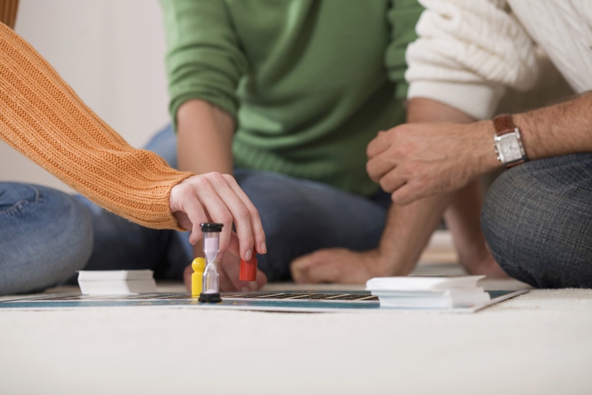 Closeup of family playing board game