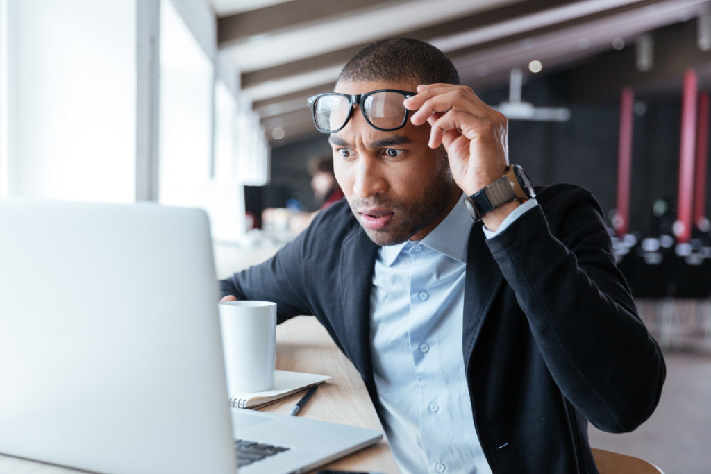 man looking at computer shocked