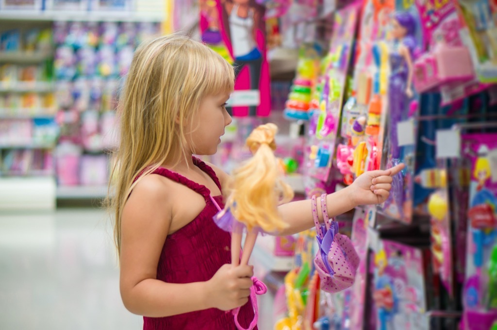 little girl holding a barbie doll