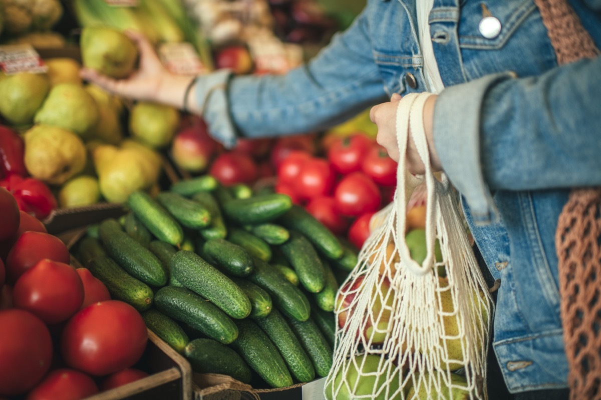 Close-up of ecologically friendly reusable bag with fruit and vegetables while grocery shopping