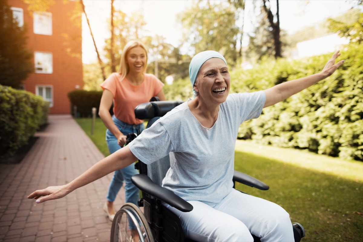 Woman in a wheelchair happy cancer patient