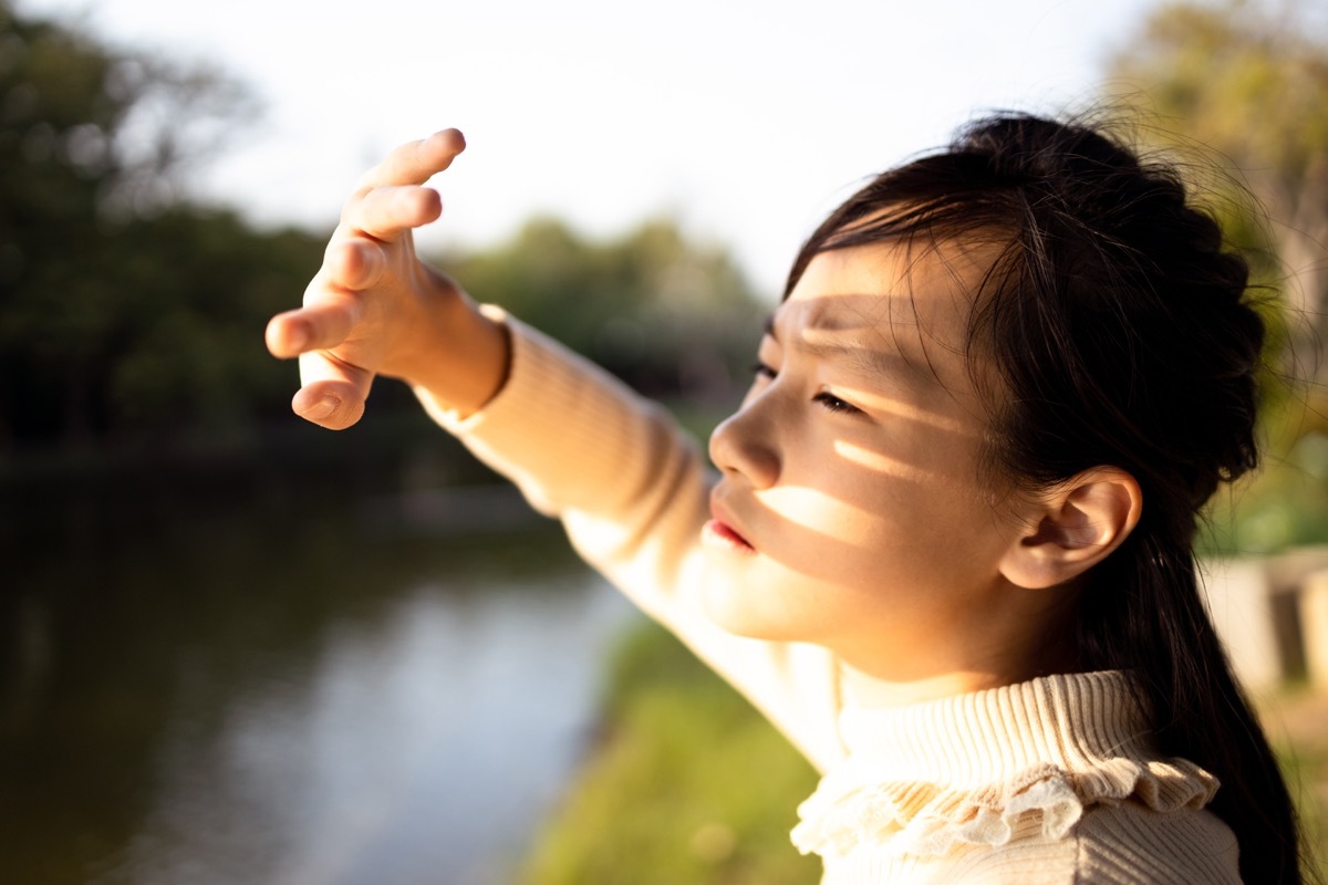 Woman blocking sun from eyes