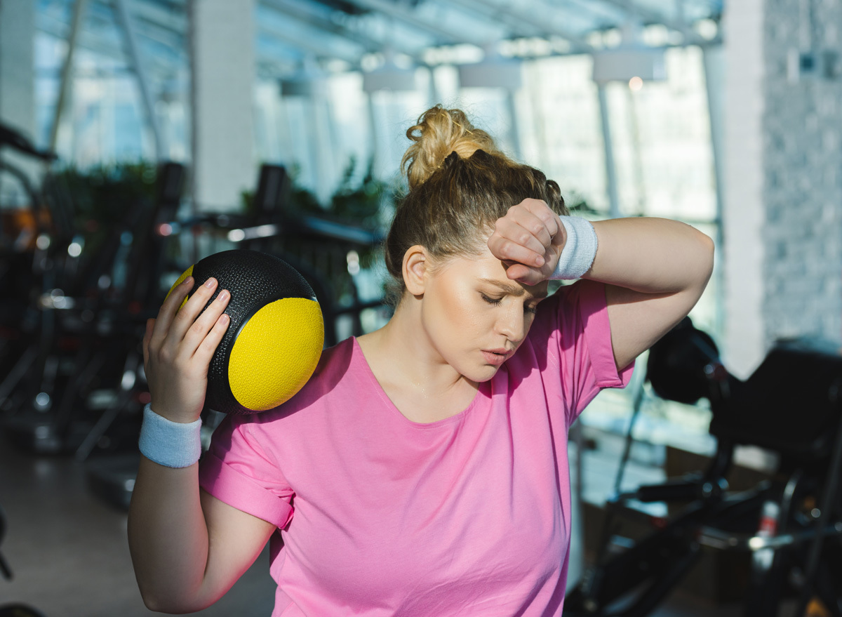 woman sweating and tired after exercising a workout