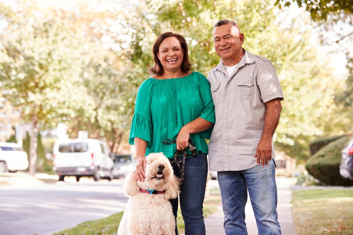 middle age latinx couple outside with dog