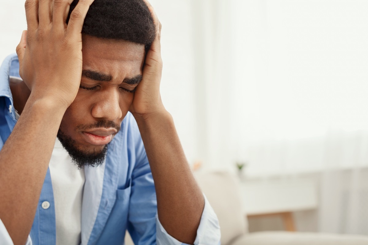 man with his hands on his head