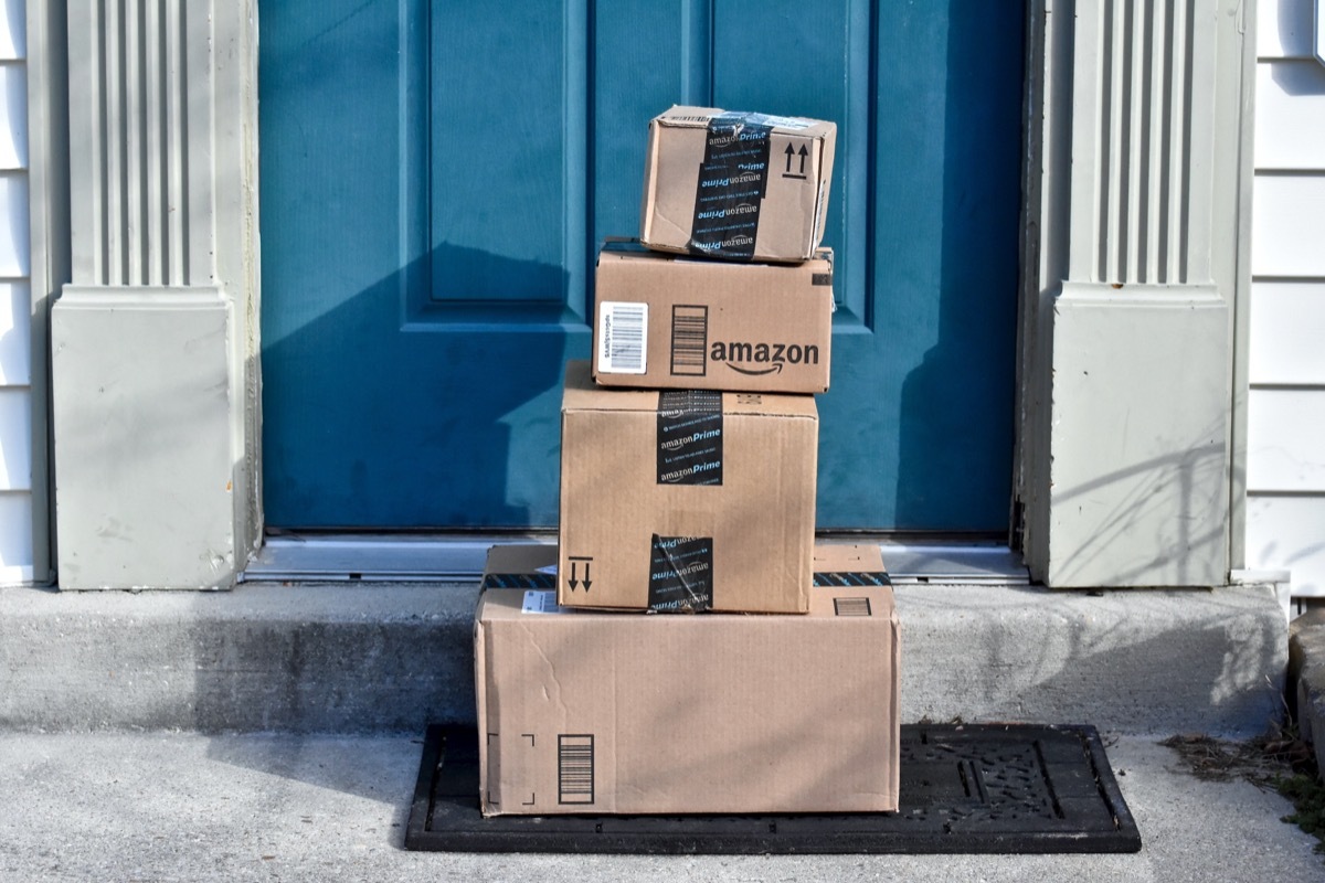 multiple amazon boxes on a doorstep