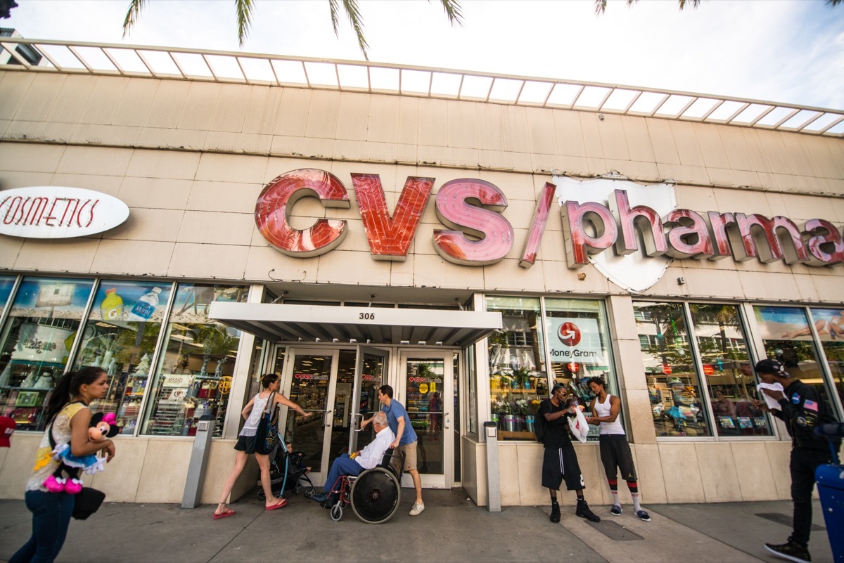 Crowds of people on Lincoln Road Mall around CVS Pharmacy entrance.