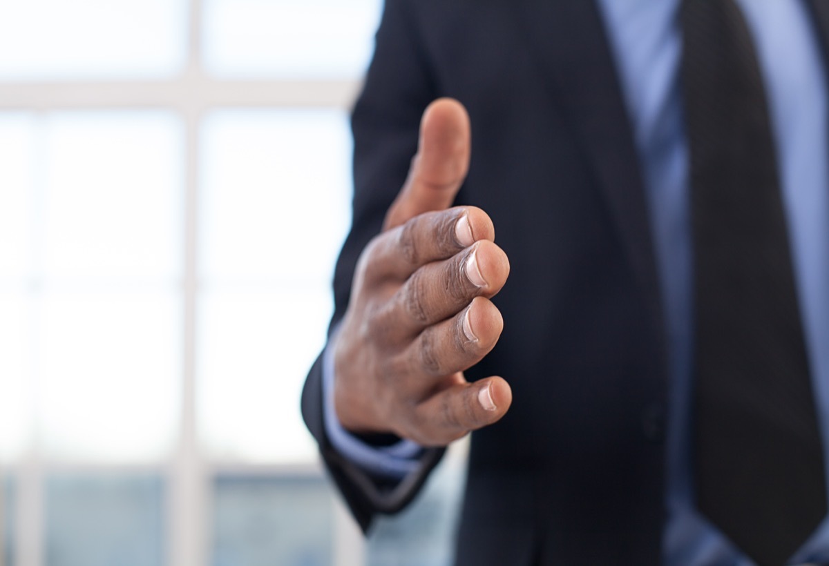 black man with hand extended