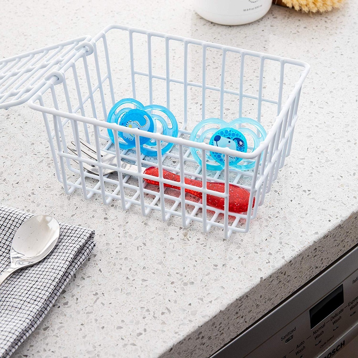 white basket with blue pacifiers, essential home supplies