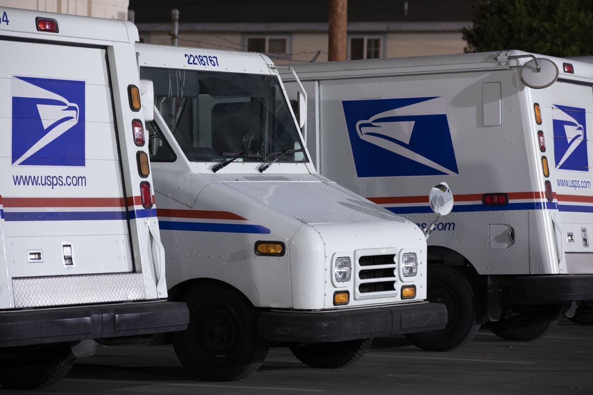 Azusa, California / USA - August 15, 2020: USPS (United States Parcel Service) mail delivery trucks sit parked for the night.