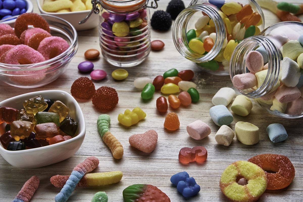 High angle view close-up of an assortment of colorful jellybeans, lollipops, candies and marshmallows.