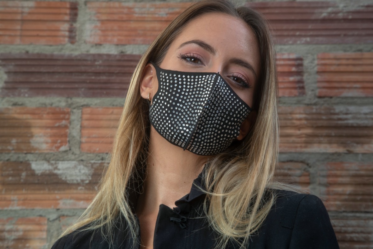 blonde woman wearing rhinestone face mask