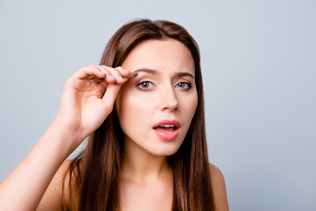 woman overplucking eyebrows