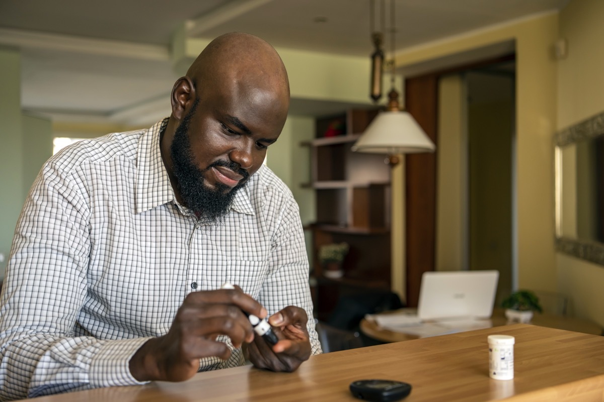 man checking his blood sugar