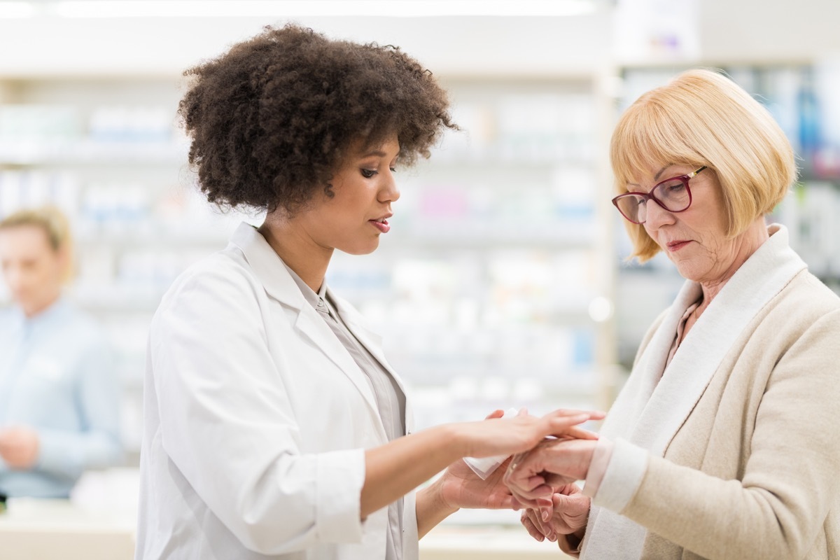 Senior Woman Talking To A Female Pharmacist