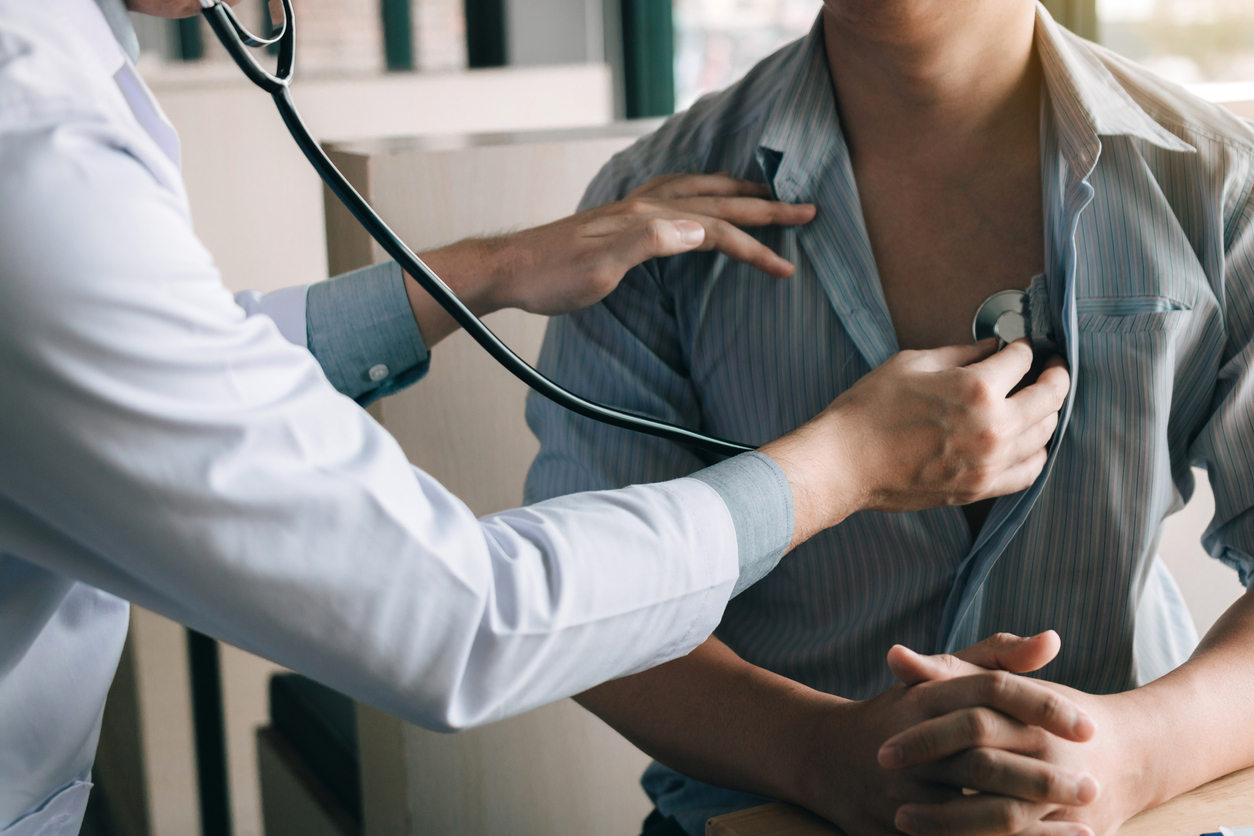 Doctor listening to patient's heartbeat.