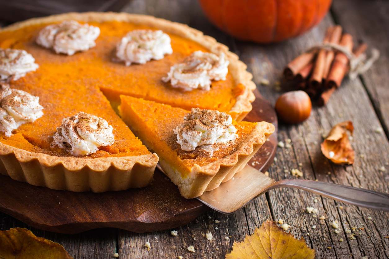 pumpkin pie with whipped cream and cinnamon