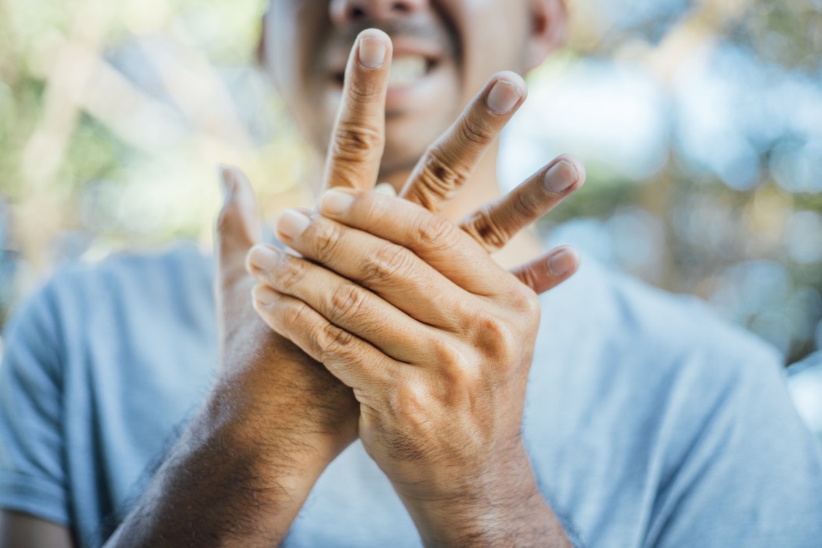 Man with swollen hand pain