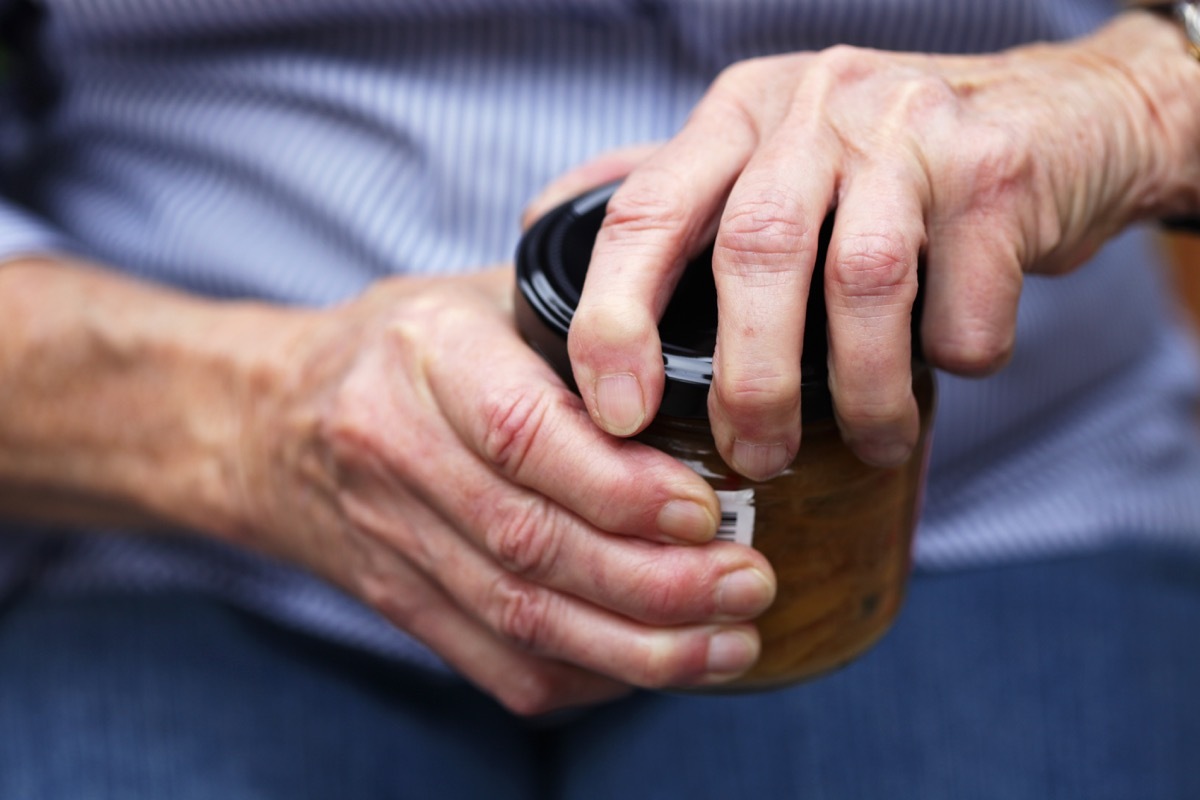 senior trying to open tough jar lid