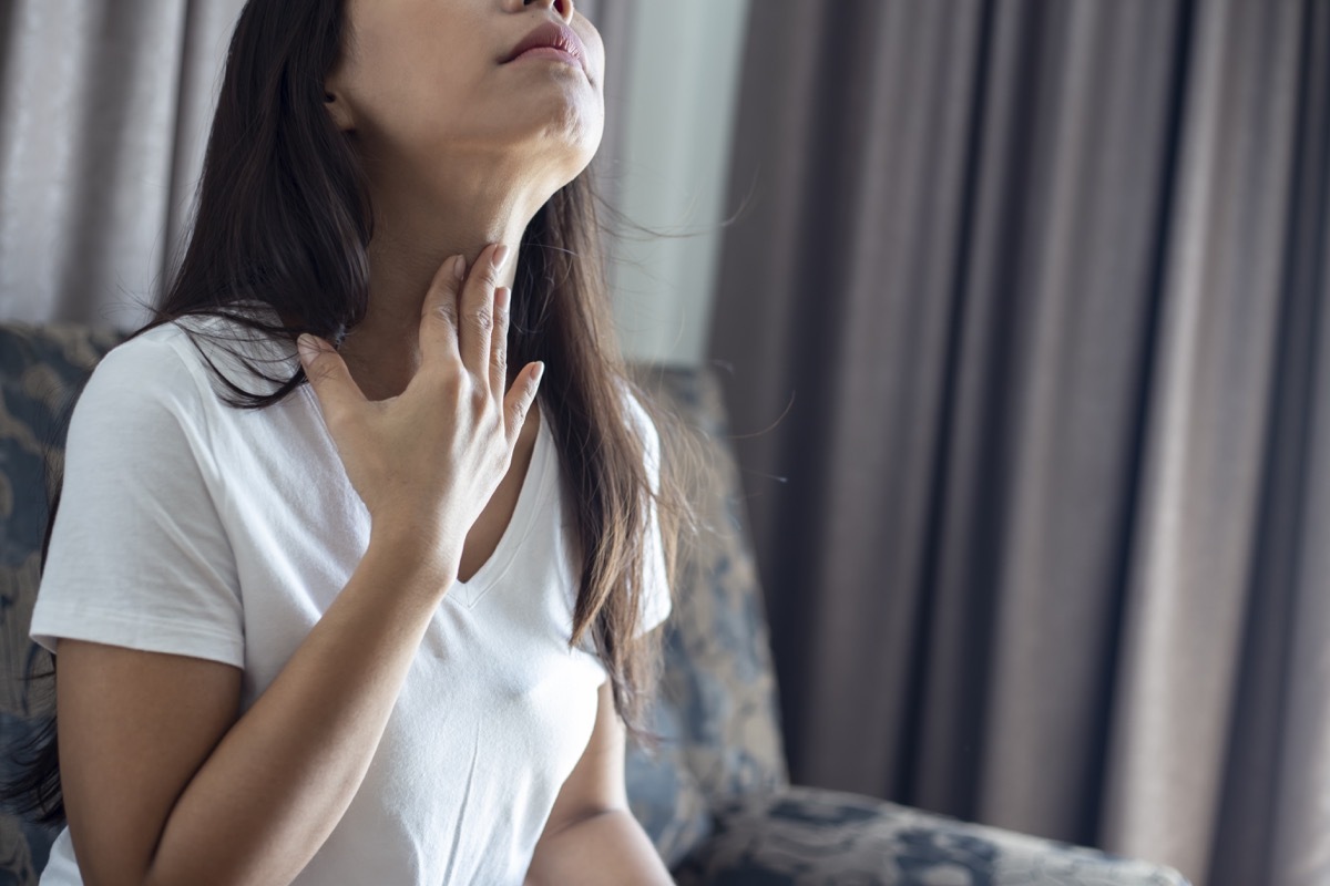 Woman suffering from sore throat.