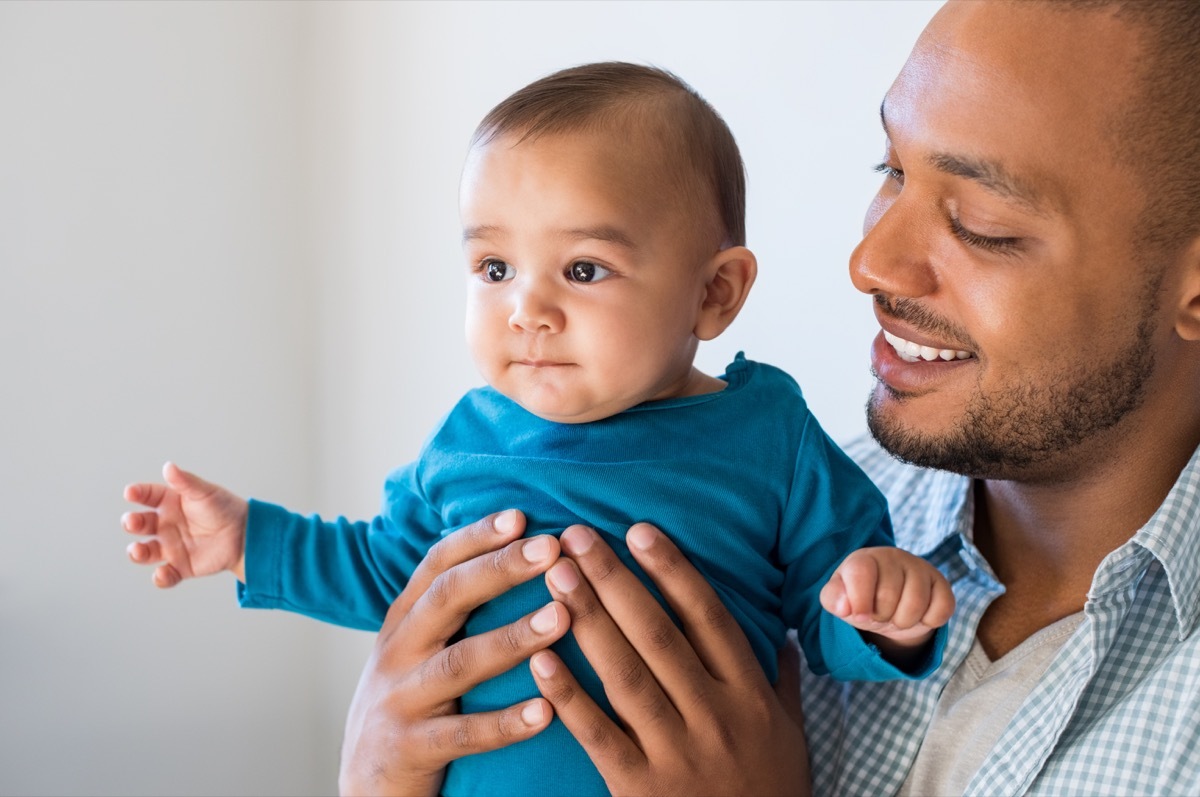 father holding baby boy