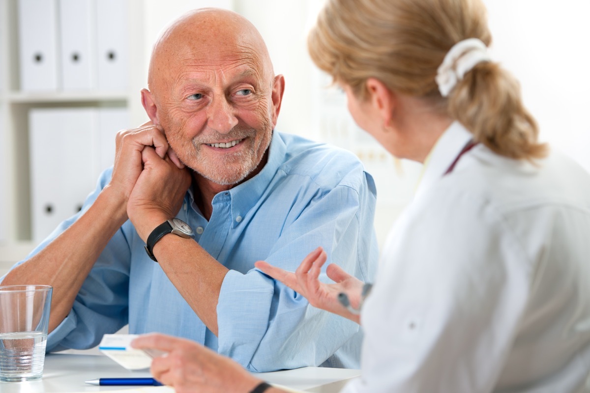 Older man talking with doctor