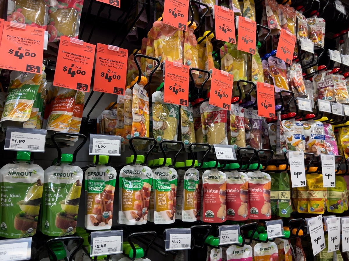 Wide view of baby food squeeze pouches for sale inside a Town and Country Market.