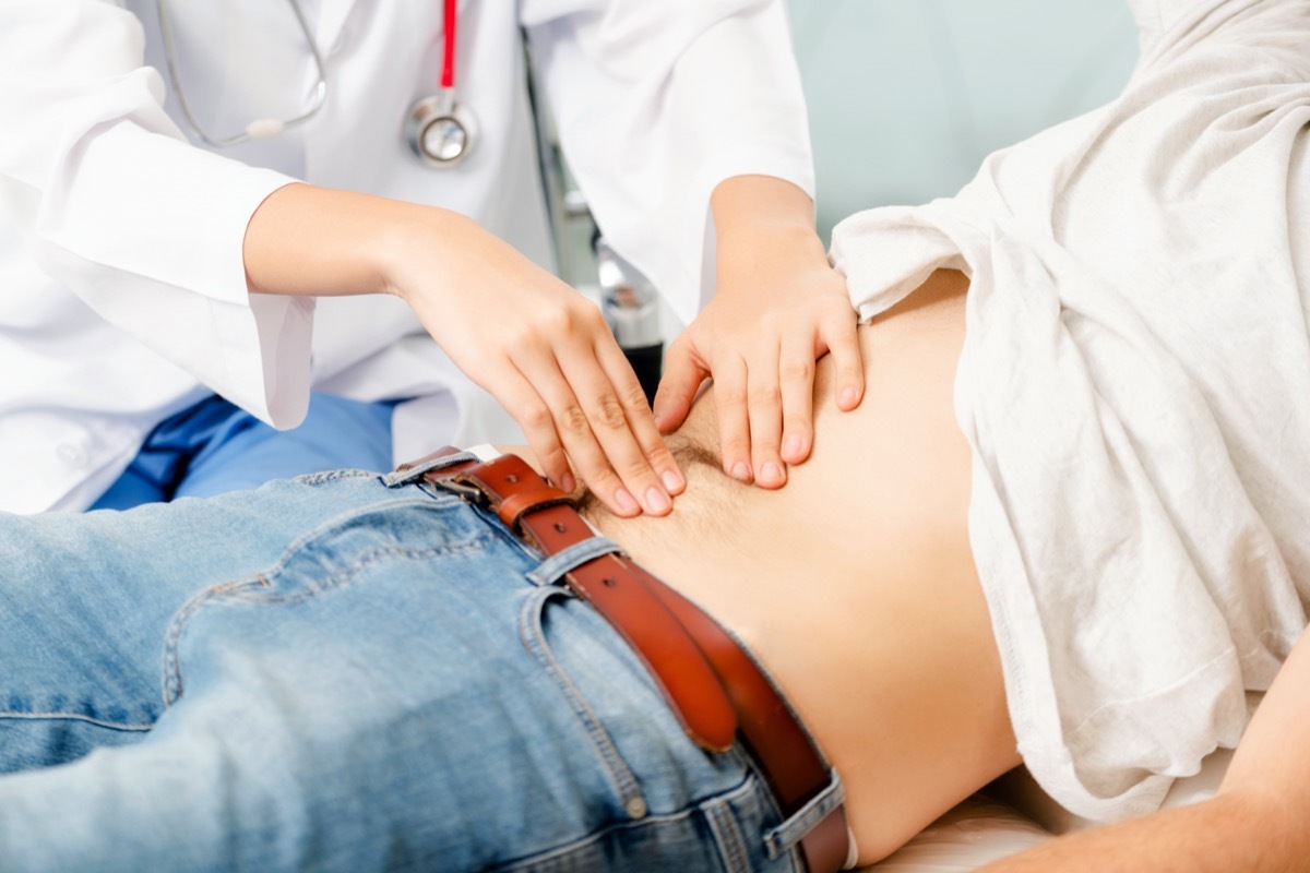 Doctor checking patient's stomach