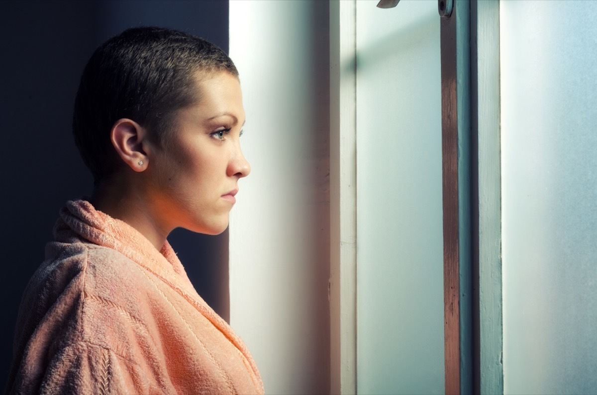 Woman with cancer looking out the window