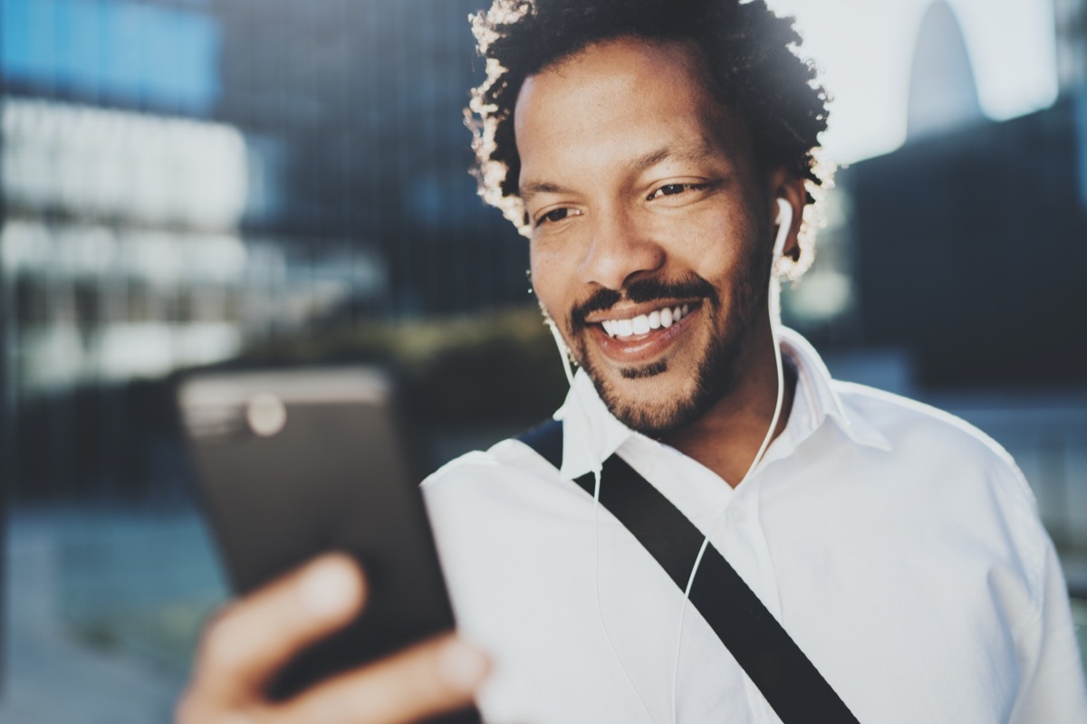 young black man walking outdoors on video call