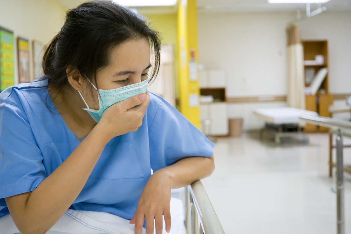 female patient coughing doctors office