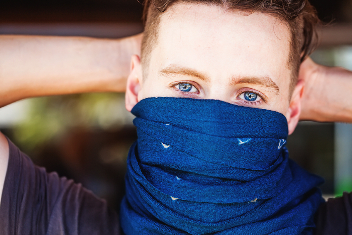 man wears bandana over nose and mouth