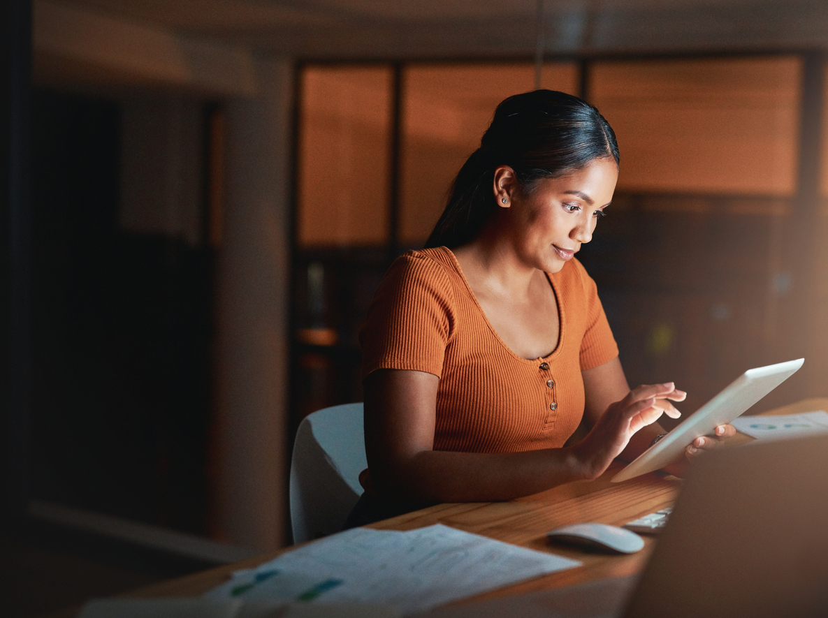 Woman staying up late at night working.