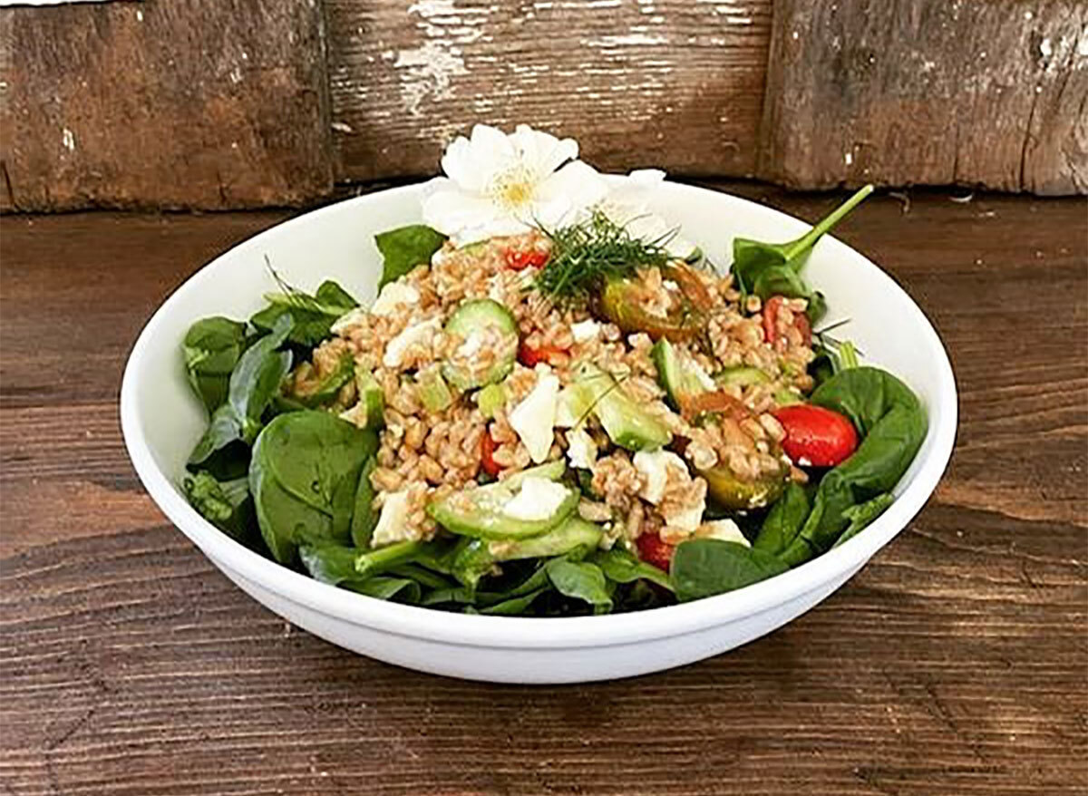 greek farro spinach salad in white bowl