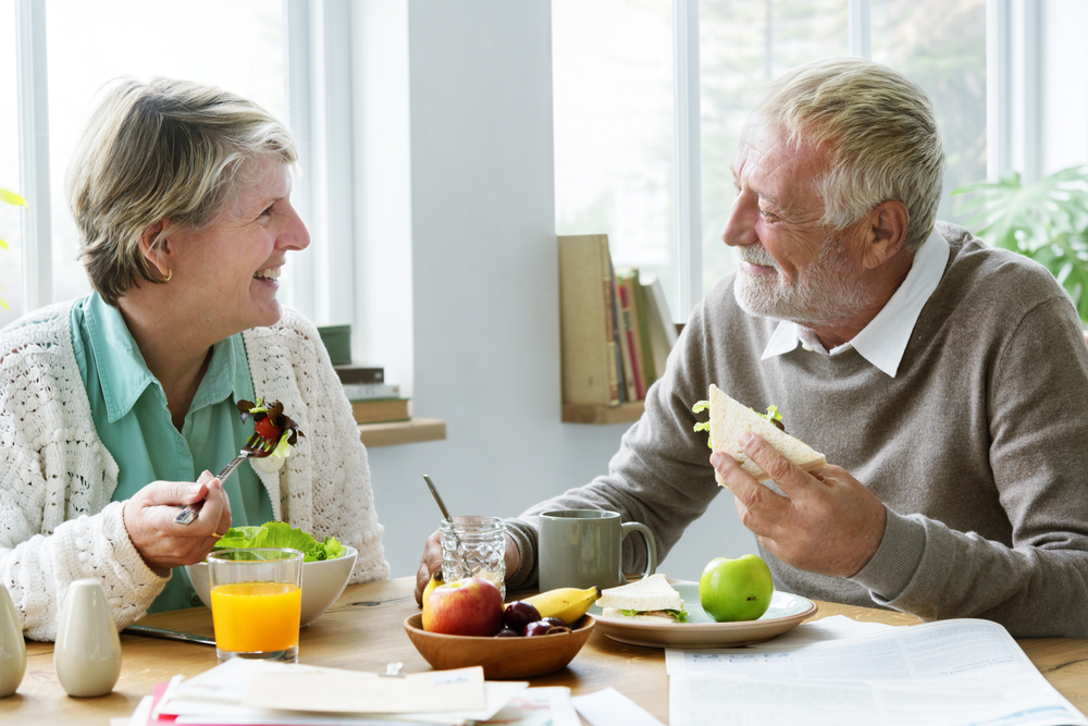 A senior couple eating a healthy lunch together