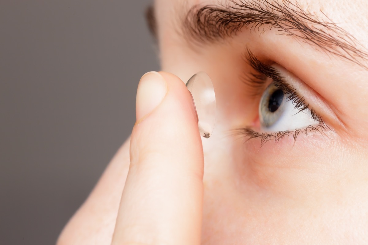 Woman putting in contact lens