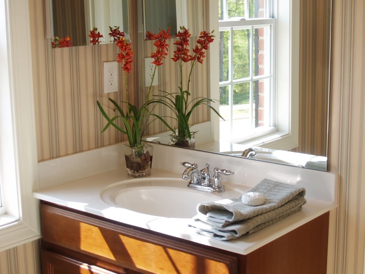 powder room with striped wallpaper