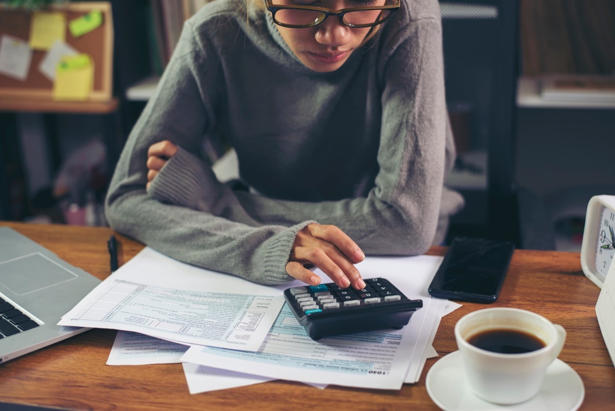 woman calculating something at a desk