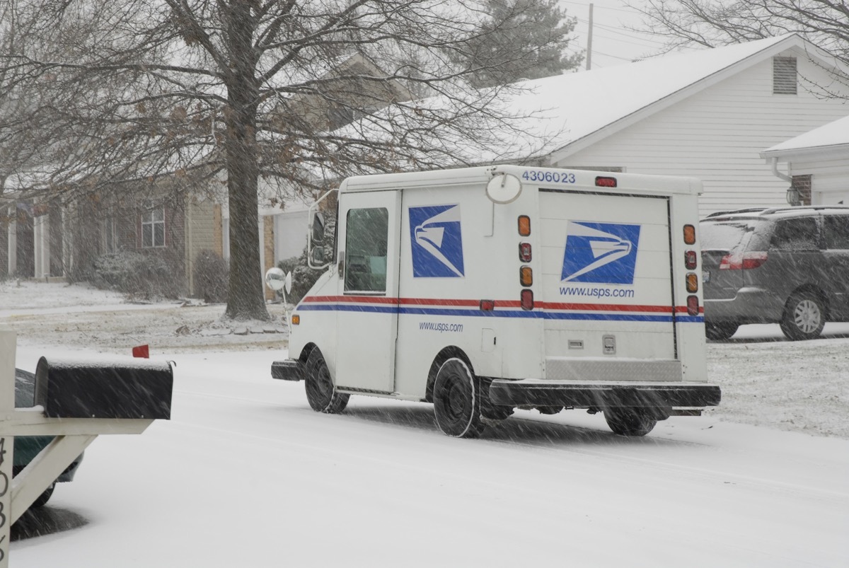 St. Peters, United States – December 23, 2008: A US Postal Service vehicle out delivering the mail during a snowstorm in Missouri