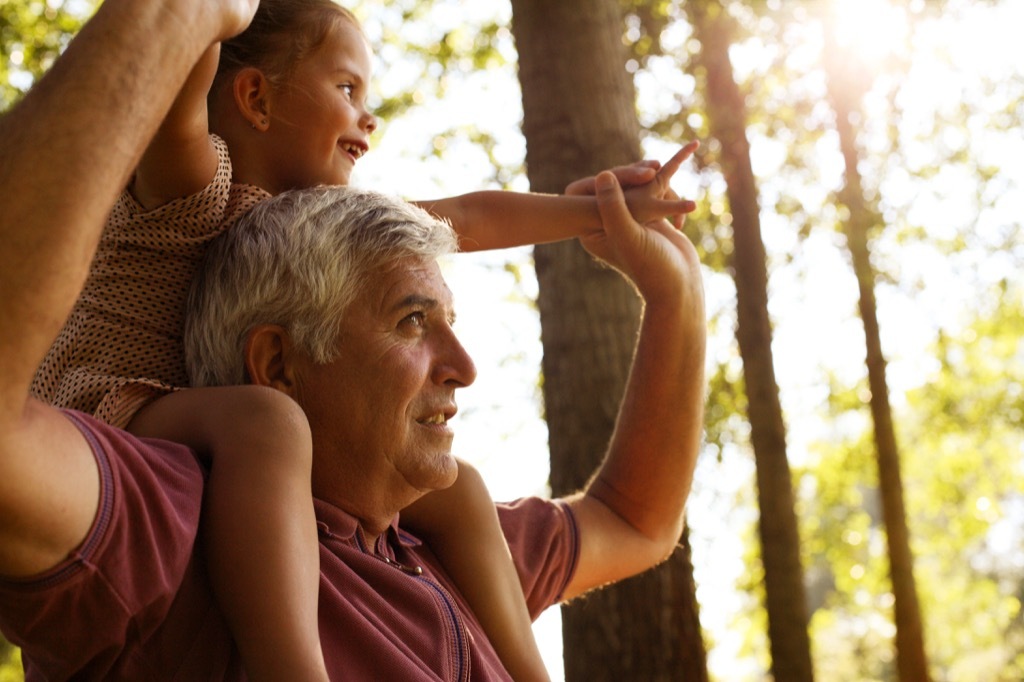 grandparent and grandchild in the woods